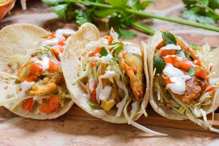 Baja fish tacos with shredded cabbage and creamy sauce
